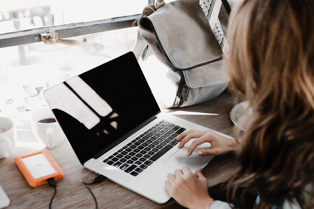 A travel agent completes a booking online.